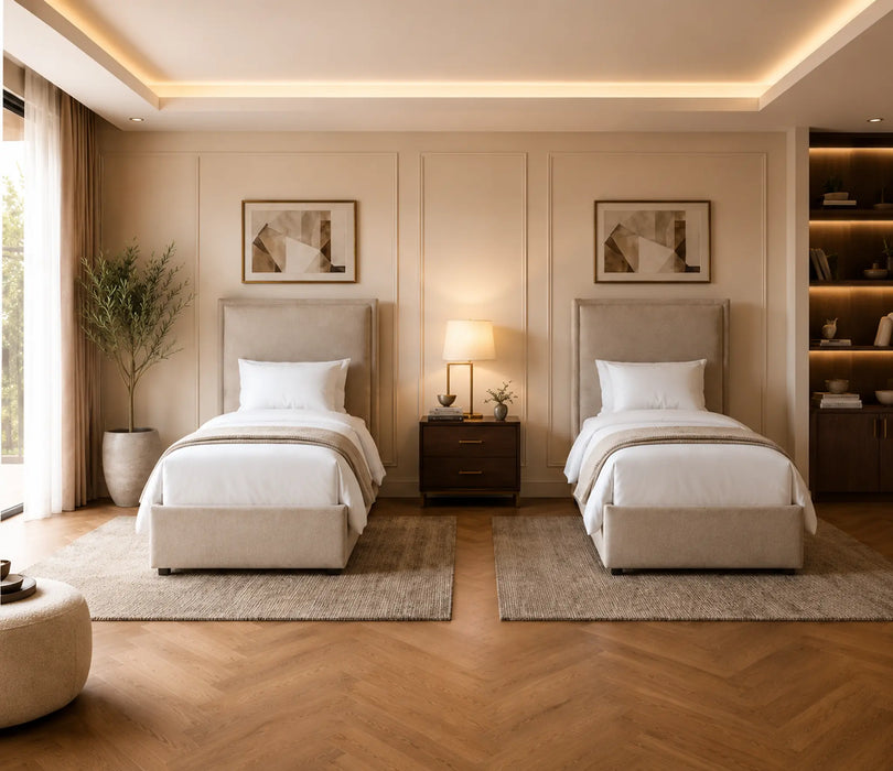 Modern bedroom with two beige beds, nightstands, and wall art.