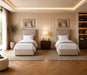 Modern bedroom with two beige beds, nightstands, and wall art.