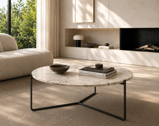 Modern living room with a marble coffee table, books, and decorative items.