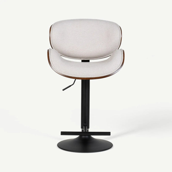 A modern swivel barstool with a light beige upholstered seat and curved backrest, supported by a black metal pedestal base with a circular footrest.