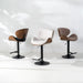 Three modern swivel bar stools with sculptural curved seats and black metal bases, shown on a clean white studio background with soft leaf shadows.