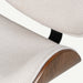 Close-up detail of a modern lounge chair showing a textured light beige fabric seat and back cushion with a curved dark brown wood shell and a black support leg, set against a plain white background.