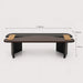 A dark brown wooden low table with black legs and light tan rectangular accents on the top, shown on a light gray background with dimension lines indicating L 140 cm, W 65 cm, and H 40 cm.