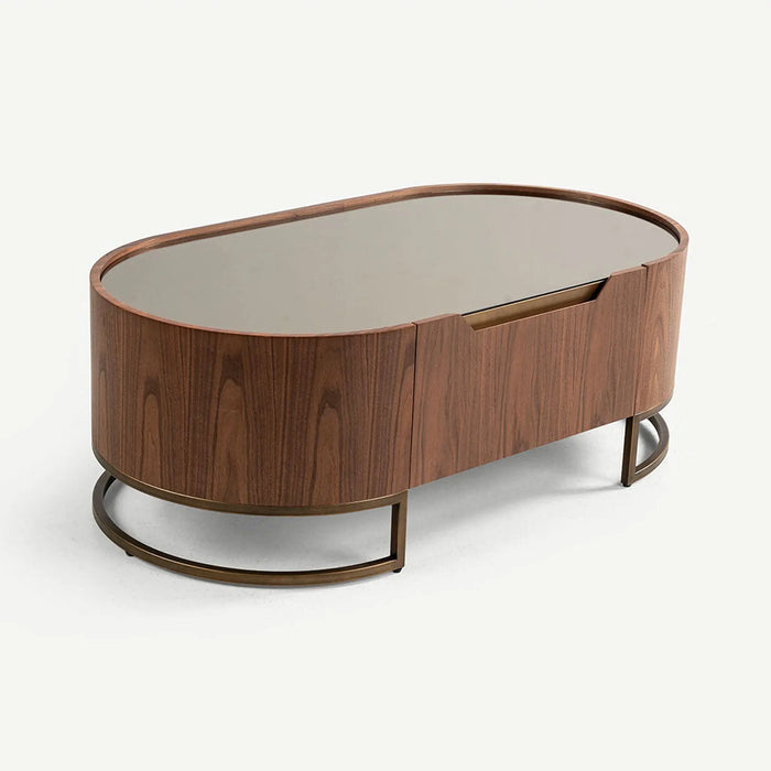 An oval mid-century modern coffee table with a dark walnut wood grain finish, a mirrored top, and a bronze metal base, shown on a light gray background.