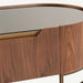 Close-up of a modern wooden sideboard or console table with a warm brown wood grain finish, a curved top, and a brass-toned metal frame and drawer edge.