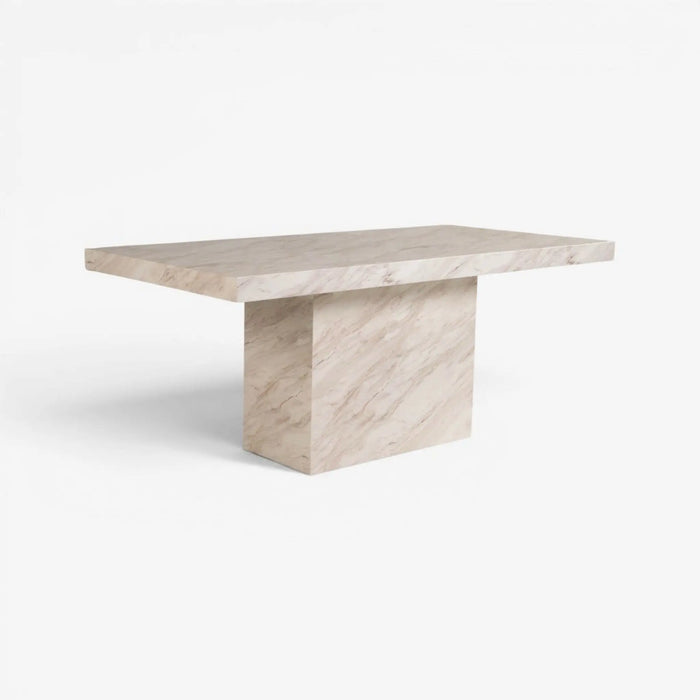 A modern rectangular table made of light beige marble with natural veining, featuring a thick square pedestal base, shown on a clean white background.