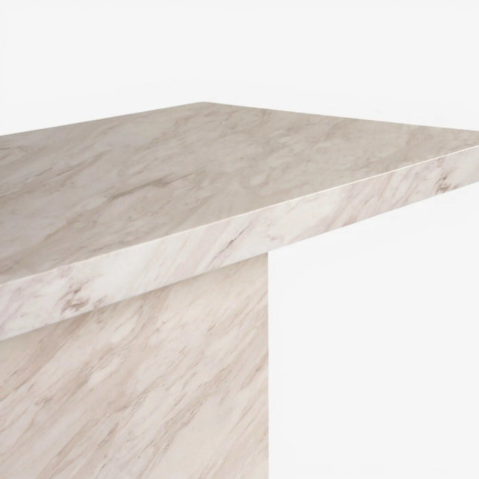 A close-up of a light beige marble tabletop with natural veining, shown against a clean white background.