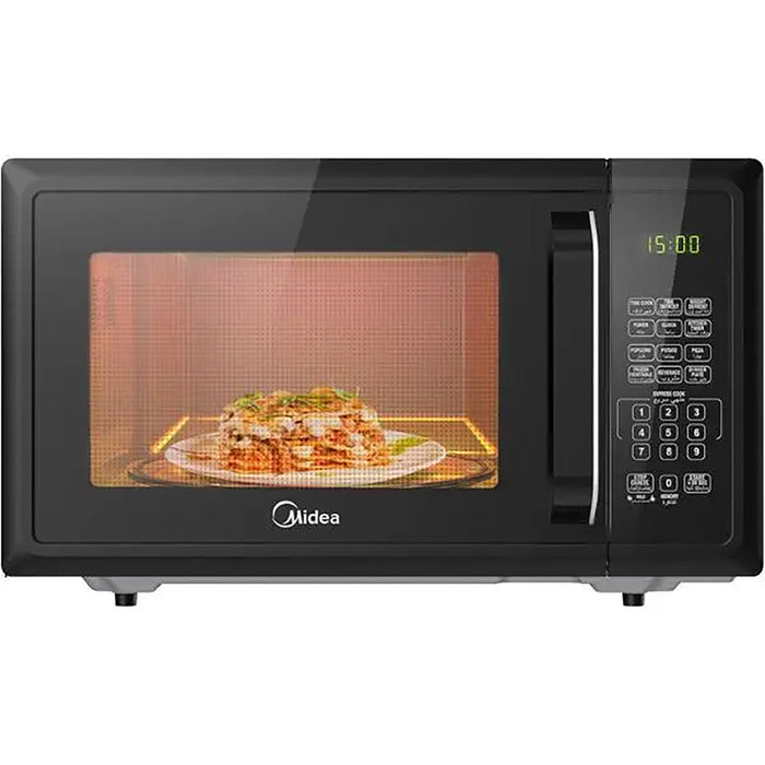 Black microwave oven with a dish of lasagna inside on a white background