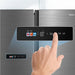 Hand interacting with a digital control panel on a refrigerator, with Midea branding visible.
