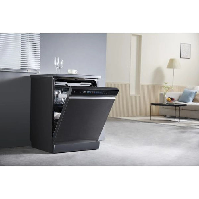 Black dishwasher in a modern kitchen setting with a living room in the background.