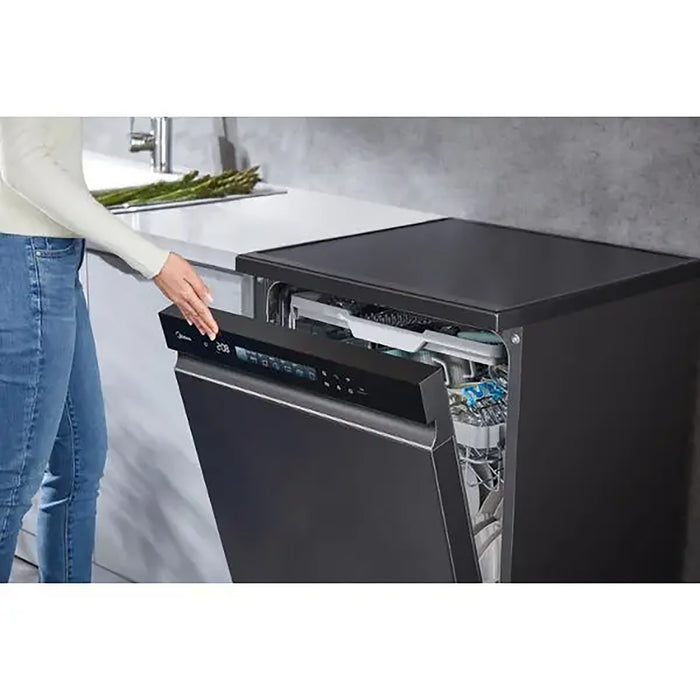 Person opening a black dishwasher in a kitchen setting