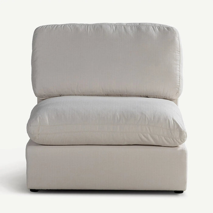 A light beige upholstered armless accent chair with a high back and a thick seat cushion, shown against a plain white background.