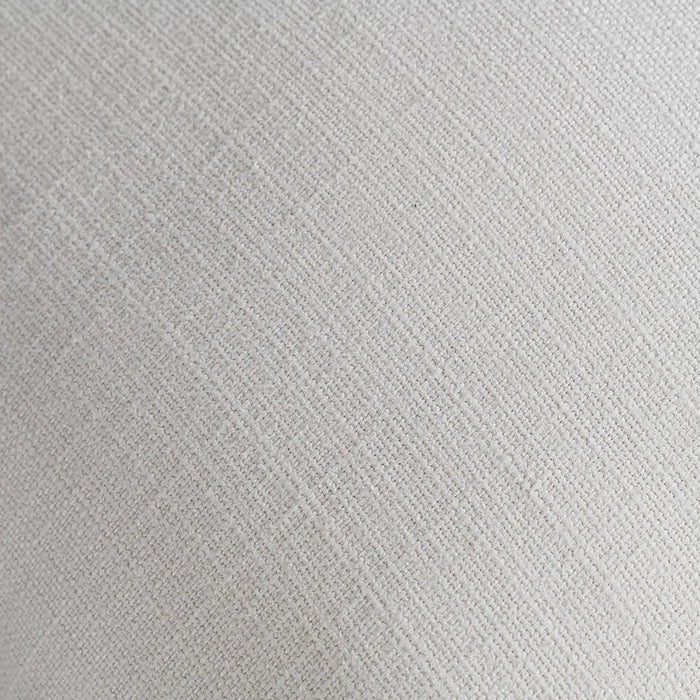 A close-up texture shot of a light beige woven fabric with a subtle diagonal twill pattern.