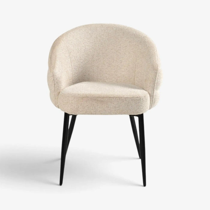 A modern upholstered accent chair with a rounded backrest, cream-colored textured fabric, and slim black metal legs, shown against a plain white background.