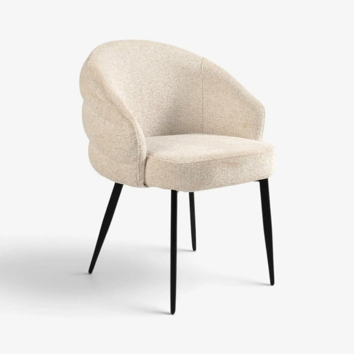 A modern upholstered accent chair with a rounded, cloud-like backrest and seat in a textured beige fabric, supported by slim black metal legs, shown on a light gray background.