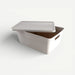 White storage box with a lid on a white background