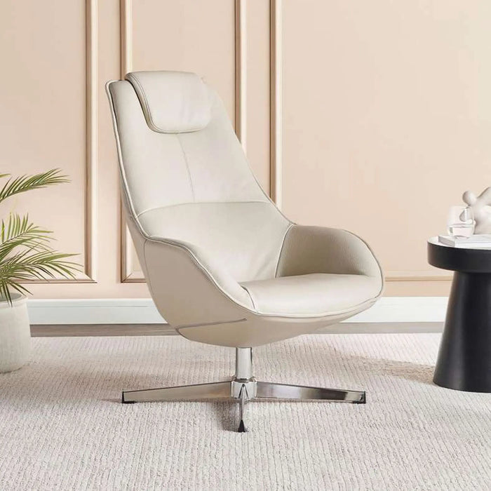Beige leather armchair in a room with a plant and small table.