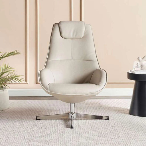 Beige armchair in a modern room with a plant and small table.