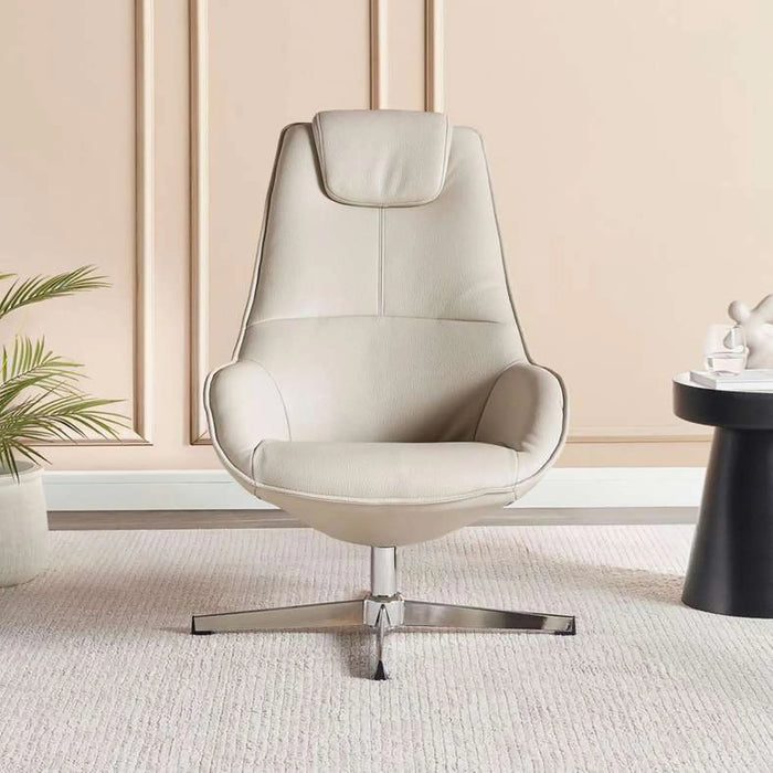 Beige armchair in a modern room with a plant and small table.