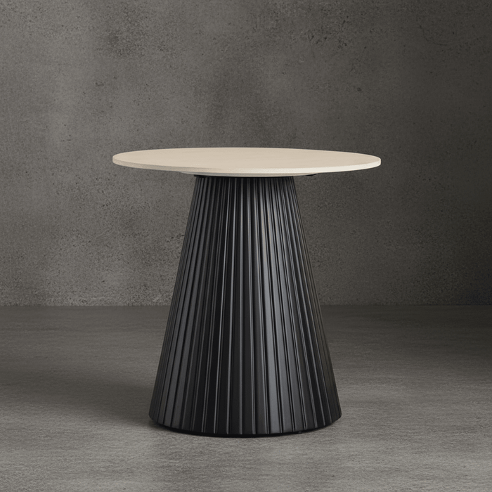 Round table with a black pleated base and beige top against a gray background