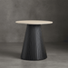 Round table with a black pleated base and beige top against a gray background