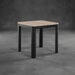 Square table with wooden top and black metal legs on a gray concrete floor.