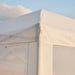 Close-up of a white canopy tent corner with a clear blue sky background