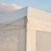 Close-up of a corner of a white tent with a clear blue sky background