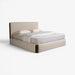 A modern platform bed with a high upholstered headboard and matching upholstered footboard, dressed in white bedding and two pillows, shown on a clean white background.
