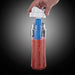 Hand holding a blender with a red smoothie inside, against a dark background