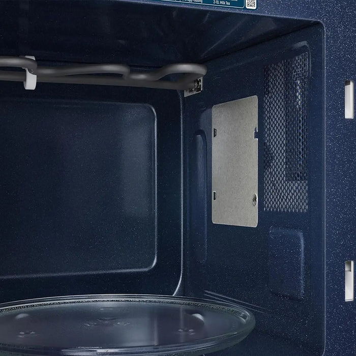 Close-up of a microwave oven interior with blue interior walls.