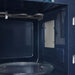 Close-up of a microwave oven interior with blue interior walls.