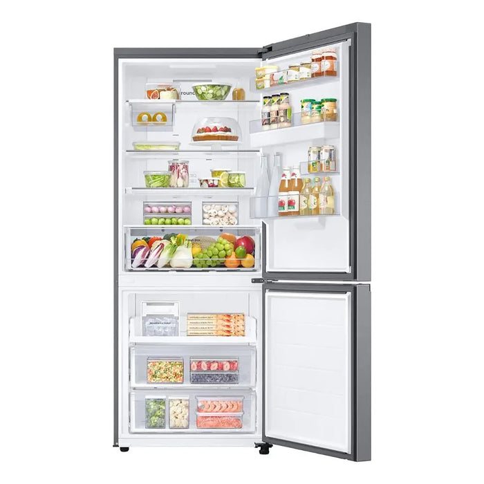 Open refrigerator with various food items on a white background