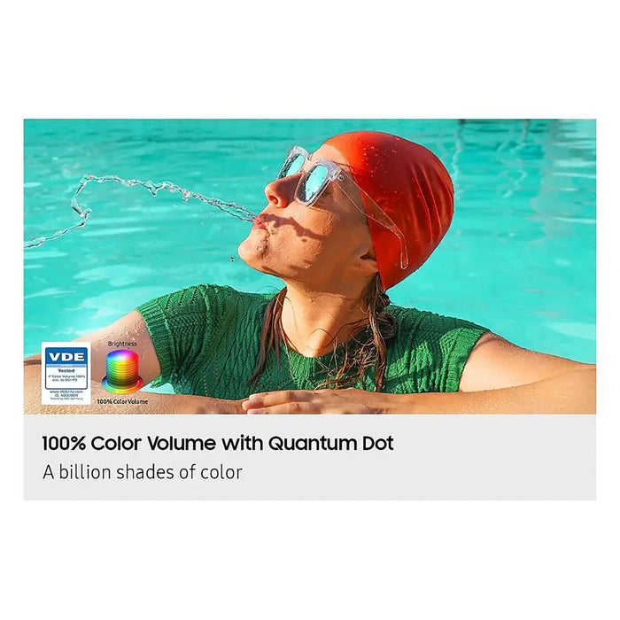 Person wearing a red swim cap and goggles in a pool, with text about 100% color volume with Quantum Dot technology.