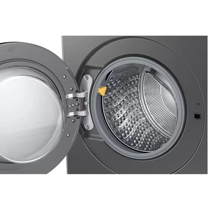 Open washing machine drum with a yellow detergent pod inside on a white background