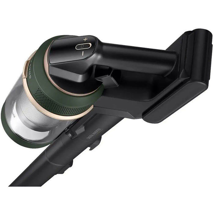 Close-up of a black and green vacuum cleaner head on a white background