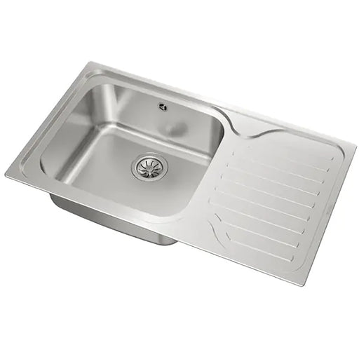 Stainless steel kitchen sink with drainboard on a white background