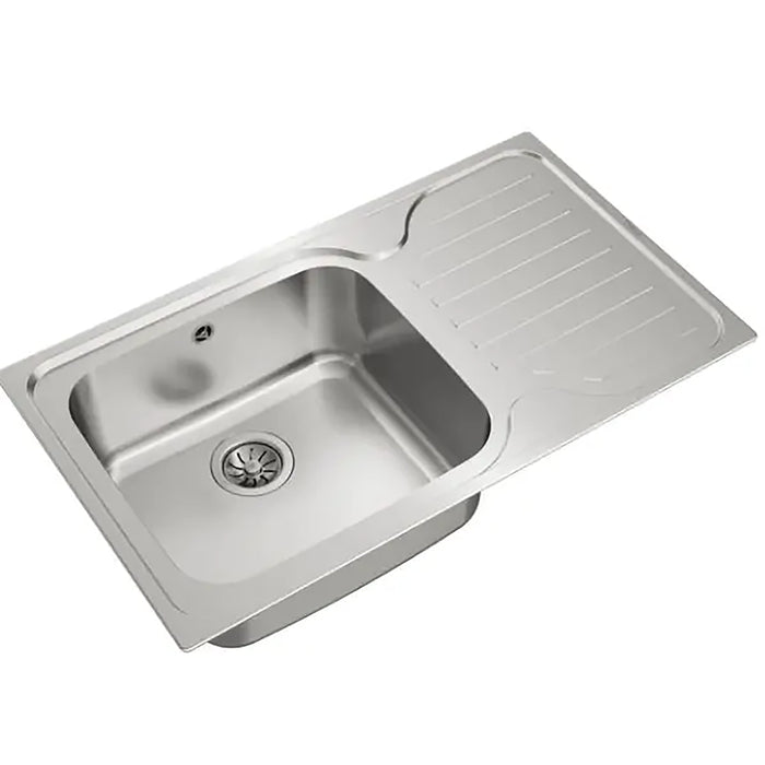 Stainless steel kitchen sink with drainboard on a white background