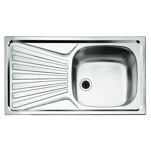 Stainless steel kitchen sink with drainboard on a white background