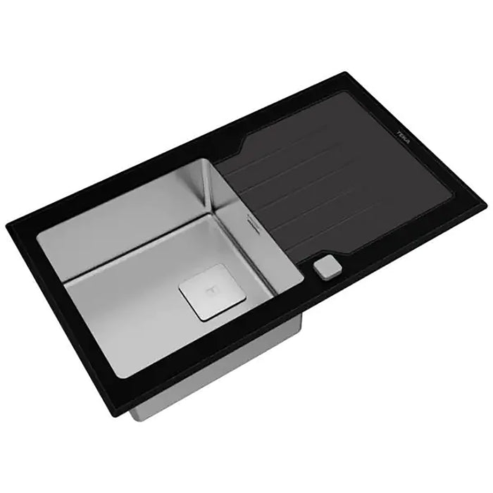 Stainless steel kitchen sink with black glass front on a white background