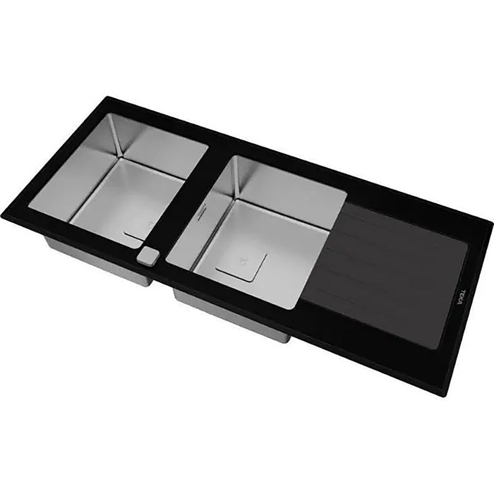 Stainless steel kitchen sink with black countertop on a white background
