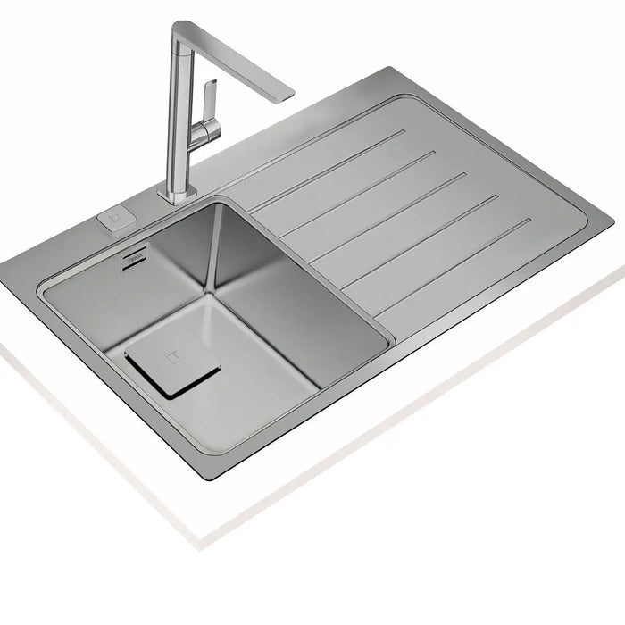 Stainless steel kitchen sink with faucet on a white background