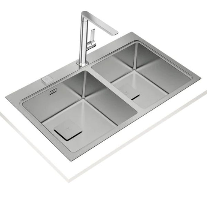 Stainless steel kitchen sink with faucet on a white background