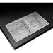 Stainless steel kitchen sink with divided compartments on a black background