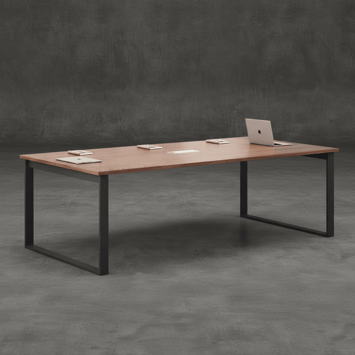 Modern rectangular office meeting table with walnut wood finish, black metal legs, and integrated cable management, styled in a contemporary workspace setting.